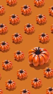 Pattern of orange pumpkins on orange background vertical banner Stock Photos