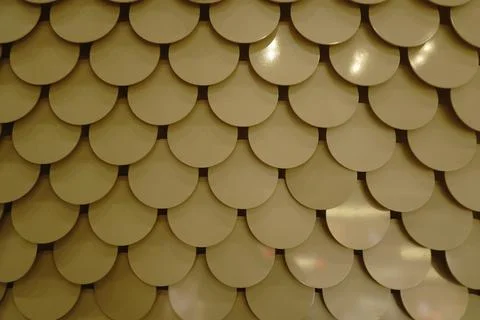 Pattern of overlapping semicircles in a neutral light-colored material creating 库存照片