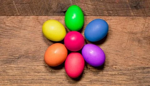 Pattern of painted eggs on wooden table for Easter Easter background with ... Stock Photos