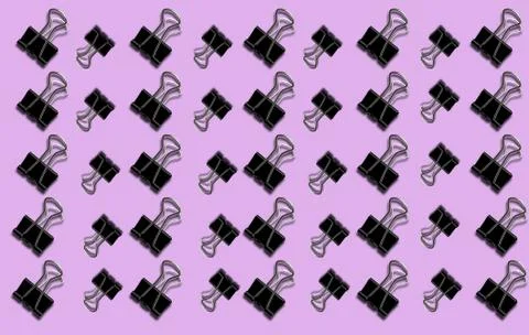 Pattern with a paper clip on a lilac background. Stock Photos