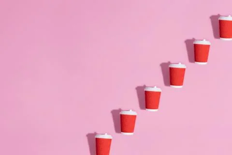 Pattern of paper cups on pink background. Stock Photos
