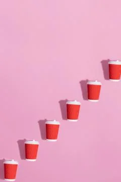 Pattern of paper cups on pink background. Stock Photos