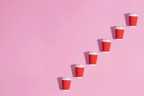 Pattern of paper cups on pink background. Stock Photos