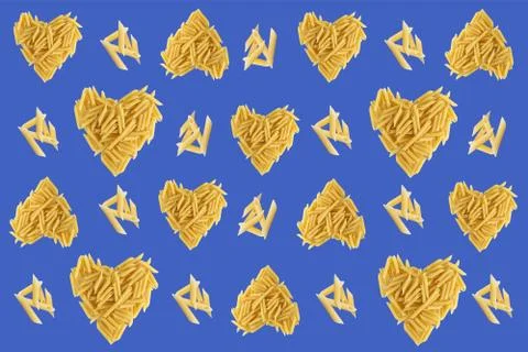 Pattern with pasta on a purple bright background. Heart shaped pasta. Favorite Stock Photos