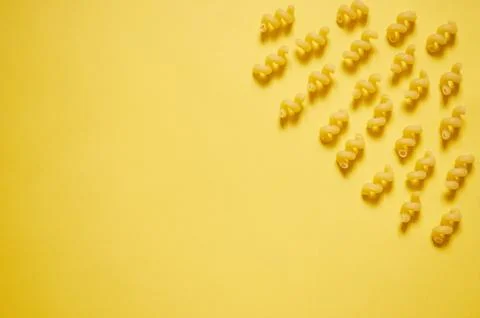 Pattern of pasta on a yellow background. The view from the top. Stock Photos