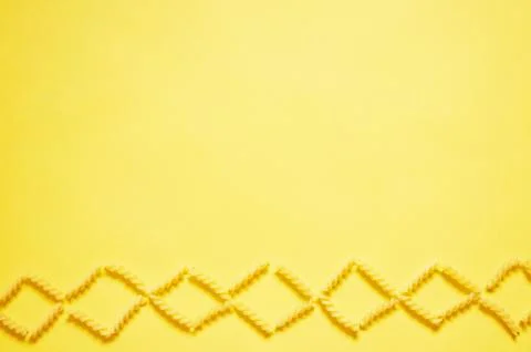 Pattern of pasta on a yellow background. The view from the top. Stock Photos