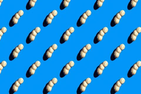 Pattern of peanuts with shell. Fashionable sunny pattern of peanuts with shel Stock Photos