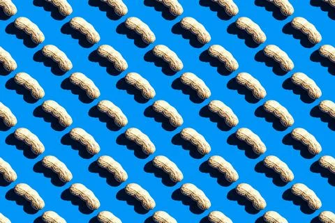 Pattern of peanuts with shell. Fashionable sunny pattern of peanuts with shel Stock Photos