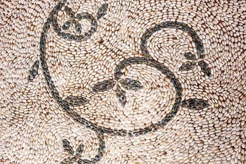 Pattern of pebbles. Sidewalk lined with small stones. Figure of pebbles. The  Stock Photos