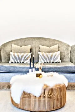 Pattern pillows on the sofa beside the blurred table Stock Photos