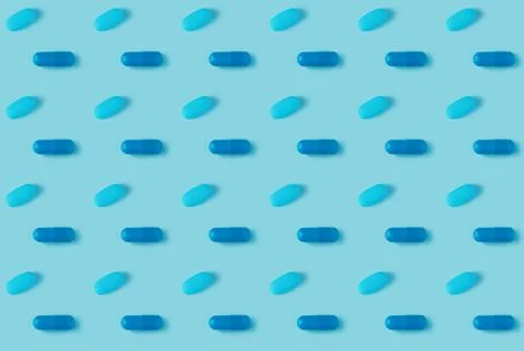 Pattern of pills on a blue background. Many pills on a blue background Stock Photos