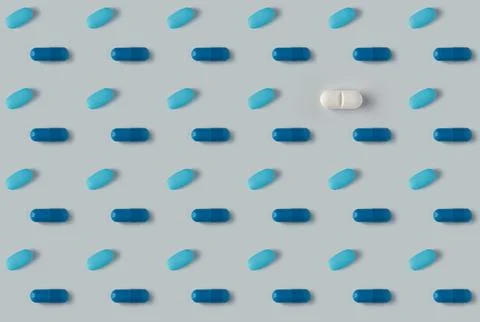 Pattern of pills on a blue background. Many pills on a light background Stock Photos