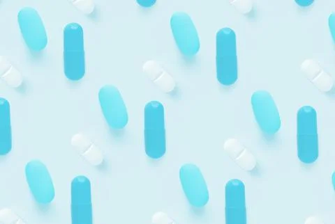 Pattern of pills on a blue background. Many pills on a light background Stock Photos