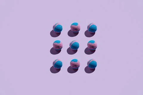 Pattern of pink and blue bath bombs on pastle purple Stock Photos