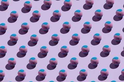 Pattern of pink and blue bath bombs on pastle purple Stock Photos