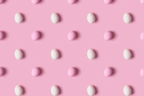 Pattern of pink and white Easter eggs over pink background Stock Photos