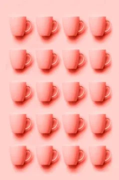 Pattern from pink cups over punchy background. Birthday party celebration, baby Stock Photos