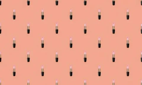 Pattern of pink lipstick tubes on peach background Stock Illustration