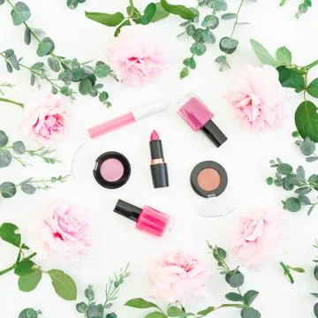 Pattern of pink rose flowers with eucalyptus and cosmetic: lipstick, shadows, Stock Photos