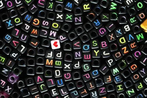 Pattern of plastic black color dice, cubes with English alphabet letters image Fotos de archivo