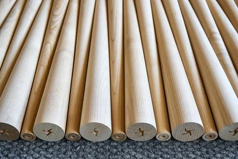 Pattern of polished conical wooden table legs on the gray carpet Stock Photos
