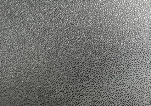 Pattern polka dots on artificial leather surface. There is light shining from Stock Photos