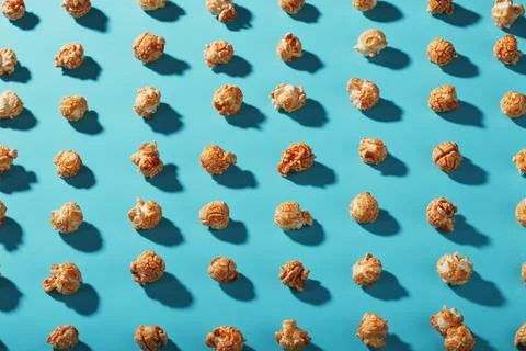 A pattern of popcorn patterns on a blue background. Stock Photos