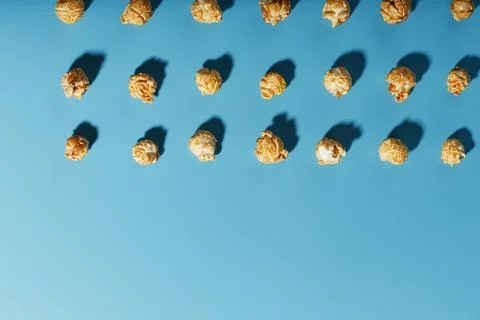 A pattern of popcorn patterns on a blue background. Stock Photos