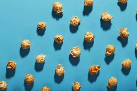 A pattern of popcorn patterns on a blue background. Stock Photos
