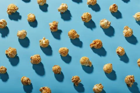 A pattern of popcorn patterns on a blue background. Stock Photos