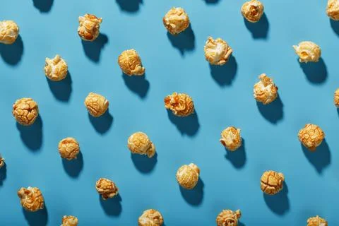 A pattern of popcorn patterns on a blue background. Stock Photos