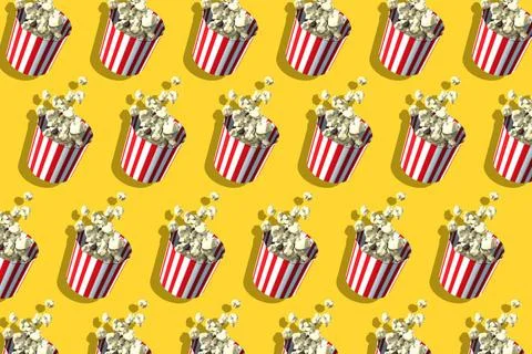 Pattern of popcorn retro boxes on yellow background. Harsh shadow. Cinema ... 스톡 사진