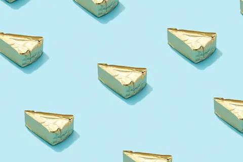 Pattern with processed cheese on blue background. Minimal creative food concept Stock Photos