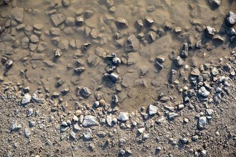 Pattern of a puddle with stones Stock Photos