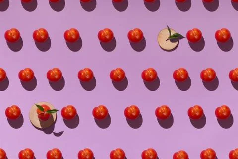 Pattern on a purple background with ripe red plums and wooden coasters Stock Photos