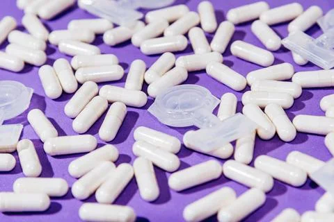 Pattern on Purple Background White Tablets and Medicine Capsules for Inhalati Stock Photos