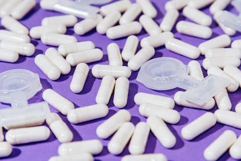 Pattern on Purple Background White Tablets and Medicine Capsules for Inhalati Photos