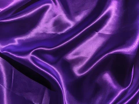 Pattern of purple fabric texture background.  wavy folds of grunge silk textu Stock Photos