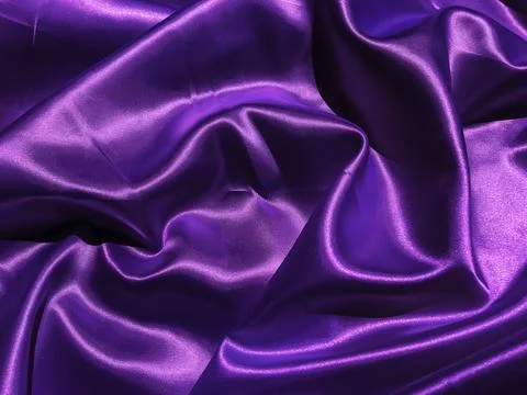 Pattern of purple fabric texture background.  wavy folds of grunge silk textu Stock Photos