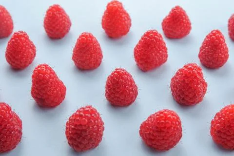 Pattern of raspberry on blue background. Flat lay summer berries - red raspbe 스톡 사진