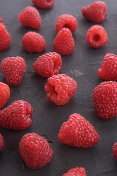 Pattern of raspberry on dark rock background. Flat lay summer berries - red r 스톡 사진