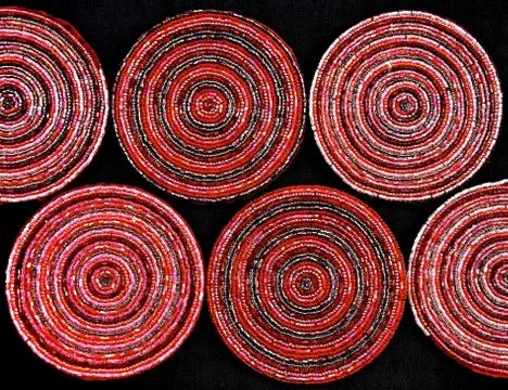 A pattern of red and pink circular beaded drinks coasters Stock Photos