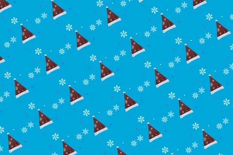 Pattern of Red and White Christmas Santa Claus Hat and Snowflakes on a Blue.. Stock Photos