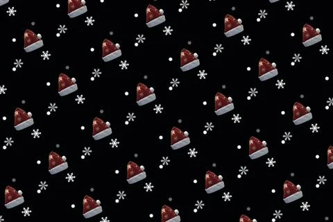 Pattern of Red and White Christmas Santa Claus Hat and Snowflakes on a Blac.. Stock Photos