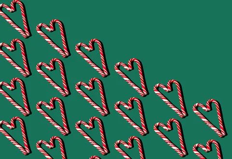 Pattern of red and white lollipops on a green background. Christmas concept Stock Photos