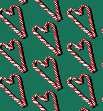 Pattern of red and white lollipops on a green background. Christmas concept Stock Photos