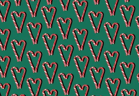 Pattern of red and white lollipops on a green background. Christmas concept Stock Photos