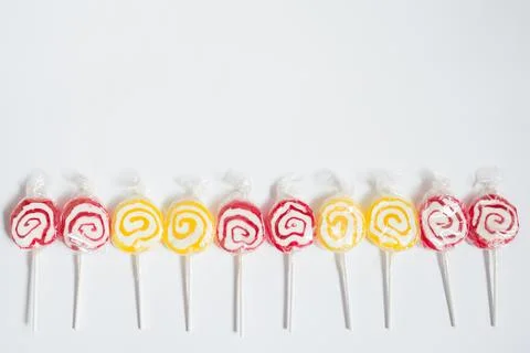 Pattern with red and yellow lollipops in a row Stock Photos