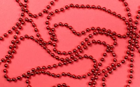 A pattern of red beads for a Christmas tree on a red background Stock Photos