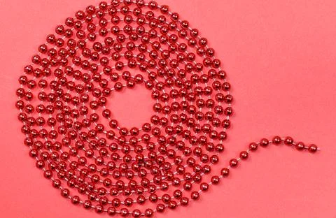 A pattern of red beads for a Christmas tree on a red background Stock Photos